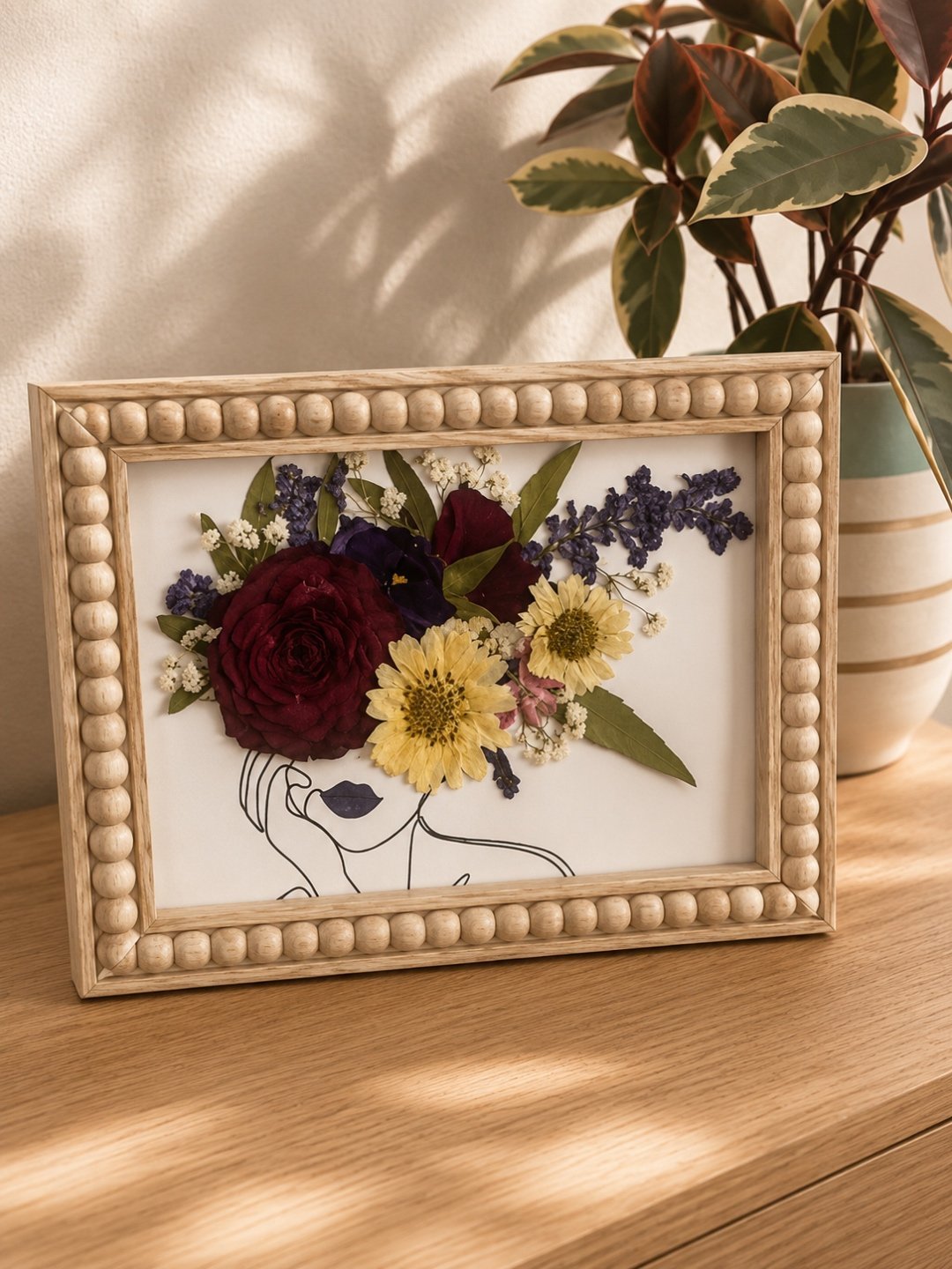 A framed pressed-flower composition under glass